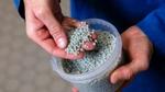 Cientista da Unilever mostrando grânulos de plástico reciclado